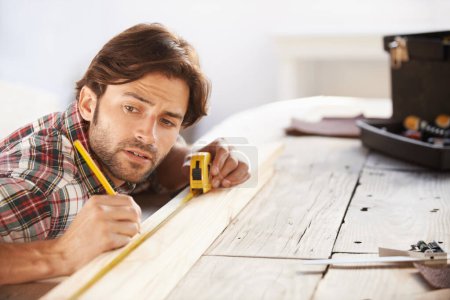 Photo for Carpenter, wood and measuring tape with man for DIY or renovation in a workshop. Craftsman, timber or measure with object for scale with construction and male person contractor with woodwork. - Royalty Free Image