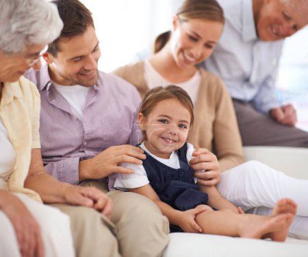 Photo for Portrait, big family and happy kid on sofa in home for bonding, love or child relax together with parents. Face, grandparents and girl with mother and father in living room with smile for connection. - Royalty Free Image
