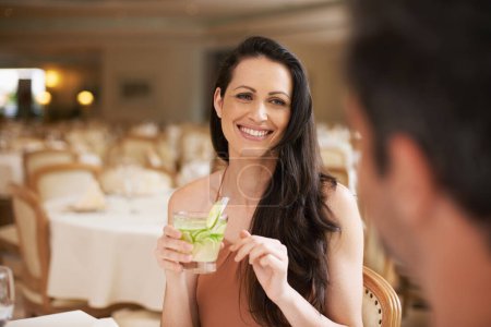 Photo for Happy woman, date and fine dining with drink for romance, love or bonding on anniversary at restaurant. Young woman smile with man on romantic dinner for good beverage, celebration or valentines day. - Royalty Free Image