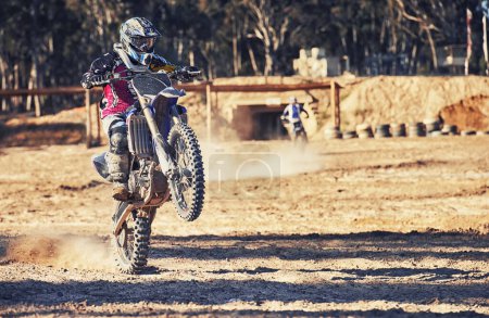 Photo for Motorcycle, action and balance with person riding on dirt track, adrenaline and stunt for extreme sports outdoor. Competition, adventure and power with risk, speed and biker on motorbike for race. - Royalty Free Image