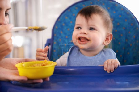 Photo for Baby, parent and spoon for feeding food in chair for morning nutrition in apartment for breakfast, development or lunch. Kid, childcare and fingers for toddler dinner or wellness, hungry or vitamins. - Royalty Free Image