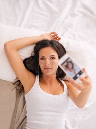 Photo for Woman, selfie and above bed in morning for vacation, hotel or photography for web blog with memory. Girl, person or influencer for profile picture, video or live streaming in bedroom for social media. - Royalty Free Image