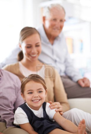 Photo for Girl, child and family with happiness on sofa for healthy development, security or comfort in apartment. Face, mother and grandfather with kid, smile and bonding for parenting and love in house. - Royalty Free Image