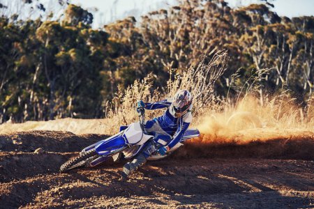 Person, professional motorcyclist and dirt track for competition, extreme sports or outdoor race. Expert rider on motorbike or scrambler for sand course, challenge or off road rally track in nature.