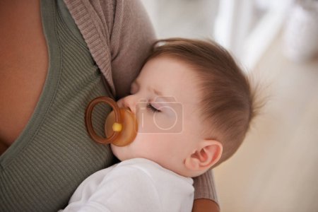 Photo for Baby, sleeping and pacifier with relax on mother for healthy development, growth and tired in bedroom. Child, rest and dummy in mouth with nap, dreaming and wellness in nursery for comfort and trust. - Royalty Free Image