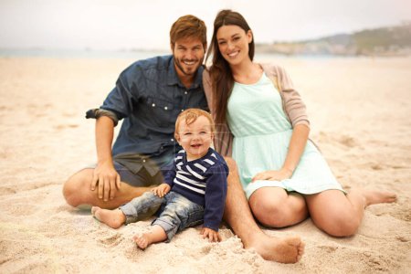 Photo for Portrait, holiday and family with smile in beach, mother and father together with cute baby boy for love. Relax, mom and dad as parents to toddler in nature, growth and development for child outdoor. - Royalty Free Image