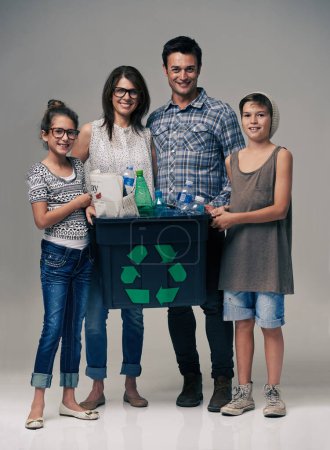 Téléchargez les photos : Parents, enfants et portraits en studio avec recyclage pour la durabilité, l'écologie et l'arrière-plan. Mère, père et enfants en famille avec récipient, plastique et bouteille pour l'environnement de nettoyage. - en image libre de droit