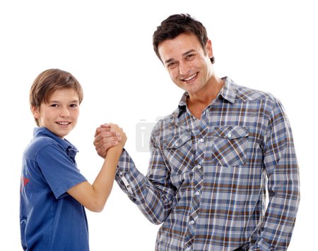 Dad, portrait and arm wrestle with child for game of strength, power or playful bonding on a white studio background. Father, son or kid with handshake in battle for challenge, parenting or childhood.