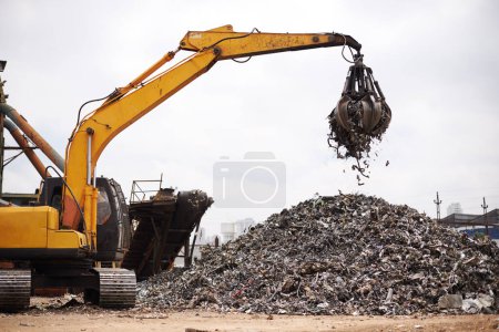 Photo for Crane, vehicle and junkyard for moving metal with sustainability, manufacturing or stop pollution. Machine, tractor and outdoor in scrapyard, plant or ecology for iron, steel industry and environment. - Royalty Free Image