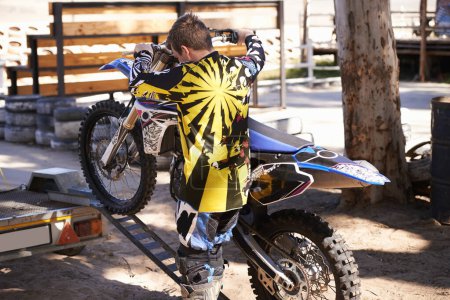 Photo for Motorcycle, man and sport for outdoor training, competition and adventure on trailer. Extreme sports, adrenaline and motorbike of young male person, athlete or biker in Minneapolis with back view - Royalty Free Image
