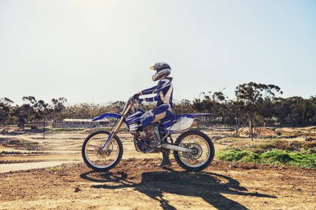 Photo for Man, motorbike and outdoor on trail for extreme sport in profile on dirt, path or countryside in summer. Person, motorcycle and gravel on road with vehicle, machine or fast transport in competition. - Royalty Free Image