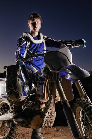 Photo for Sport, competition and portrait of man with off road motorbike, confidence and gear for race challenge. Adventure, adrenaline and serious face of athlete on extreme course with dirt bike in evening. - Royalty Free Image