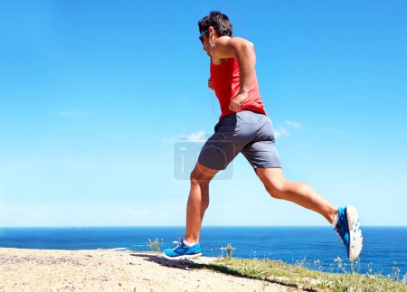 Photo for Man, beach and earphones for workout outdoors, jog and athlete for performance training by sea. Male person, full body and back for run in nature, blue sky and listen to music for exercise on mockup. - Royalty Free Image