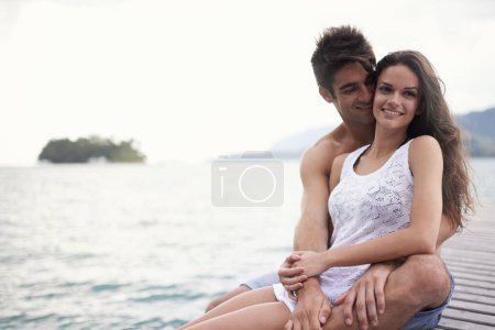 Photo for Love, smile and couple at ocean on vacation, holiday or travel together outdoor at pier. Romance, man and happy woman at sea for adventure, care and connection in summer by water in nature on mockup. - Royalty Free Image