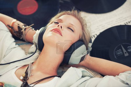 Photo for Relax, music and woman with headphones on floor for streaming subscription, audio and radio. Podcast, smile and above of person listening to playlist, song and track in home with vinyl records. - Royalty Free Image