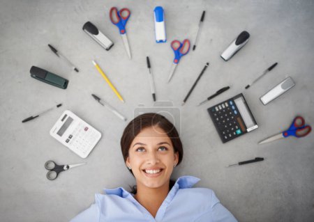Photo for Happy woman, thinking and stationery with tools for accounting, finance or creative above. Top view of female person, accountant or employee with smile or startup equipment on gray studio background. - Royalty Free Image