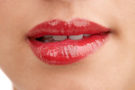 Photo for Person, red lipstick and closeup of mouth with makeup for cosmetics, gloss or glow in treatment. Colorful lips of woman or model with bite in satisfaction for mouth, oral or beauty in cosmetology. - Royalty Free Image