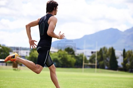 Photo for Athlete male person, run and outdoor for race, jog and activewear in workout and training for wellness and sprint. Cardio, wellbeing and sport for exercise, health and fitness on grass for summer. - Royalty Free Image
