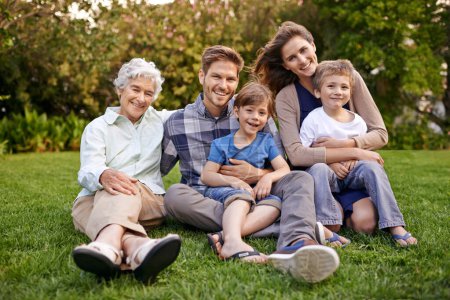Photo for Nature, portrait and children with parents and grandmother relaxing on grass in outdoor park or garden. Smile, family and boy kids on lawn with mom, dad and grandma for bonding in field together - Royalty Free Image