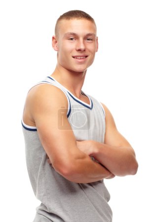 Photo for Portrait, fitness and smile with man arms folded in studio isolated on white background for sports. Exercise, health and workout with confident young athlete in tank top for strong muscle training. - Royalty Free Image