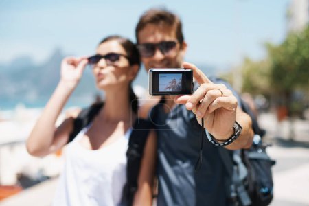 Photo for Happy couple, smile and travel with camera for selfie, sunglasses and backpack outdoor. People, man and woman on adventure for break or holiday, trip and memories in relationship together. - Royalty Free Image