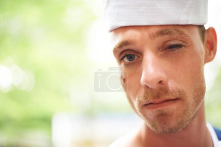 Photo for Portrait, hat and man wink outdoor in sailor outfit at music festival, event or summer carnival. Face, blink and serious person at party for celebration concert, bokeh and facial paint in France. - Royalty Free Image