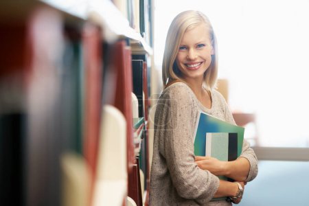Photo for Happy woman, library and books, portrait for education and knowledge with smile on campus. College student, bookstore and reading material for learning, happy with university and academic development. - Royalty Free Image