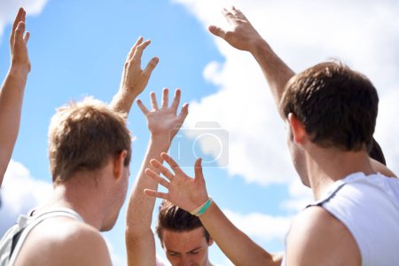 Photo for Men, group and hands in air for sports on field with motivation, support and challenge with cheers. People, team building and circle with solidarity for contest, competition and workout with games. - Royalty Free Image