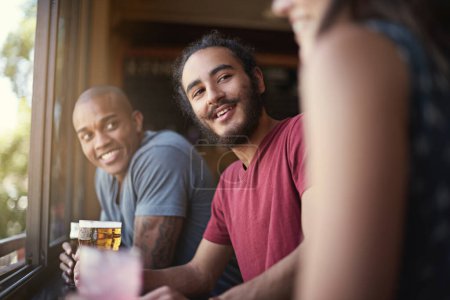 Photo for Friends, people or happiness in pub with beer for happy hour, relax or social event with window view. Diversity, listen or drinking alcohol in restaurant or club with smile for bonding or celebration. - Royalty Free Image