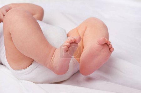Photo for Closeup, newborn baby or feet for relax, bed and nap for healthy childhood, care and development. Bare foot, leg and toes of young child for calm, rest and sleeping in peaceful nursery for dreaming. - Royalty Free Image