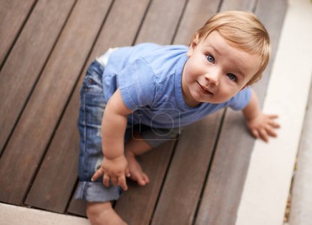 Photo for Floor, above or portrait of baby in home for fun playing, happiness or learning alone on porch. Relax, boy or face of a toddler on ground with smile for child development or growth in house top view. - Royalty Free Image