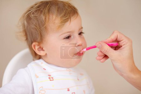 Photo for Spoon, baby and high chair for eating, food and nutrition for healthy, childhood development. Young child, care and hungry for tasty, delicious and meal for wellbeing, growth and bonding together. - Royalty Free Image