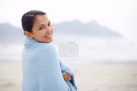 Photo for Woman, towel and beach with portrait, smile and sand for relax and rest in cape town. Tourist, ocean and sea for travel, adventure and holiday with blanket for comfort and positivity in nature. - Royalty Free Image
