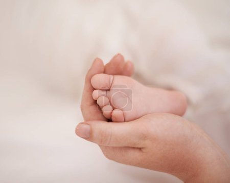 Photo for Feet, hand and parents with infant, support and love of parent for bonding or wellness. Family, close up of caring person holding baby toes for security, protection and childhood development. - Royalty Free Image
