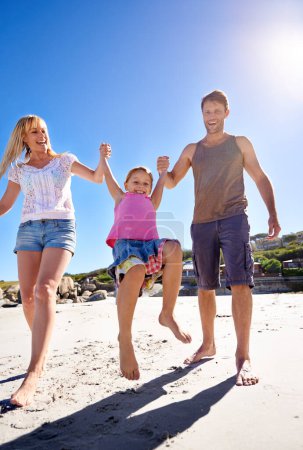 Photo for Parents, swing and holding hands with girl at beach in portrait with care, love or bonding in summer on holiday. Father, mother and daughter with games, connection or playing in sunshine on vacation. - Royalty Free Image