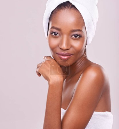 Photo for Woman, face and towel for beauty in studio with skincare, dermatology and self care on a white background. Portrait of a young model or African person with smile for hygiene, cosmetics or cosmetology. - Royalty Free Image