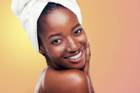 Photo for Portrait, smile and black woman with hair towel in studio for skincare, wellness or body care on orange background. Beauty, cleaning and face of African female model with cosmetic, shine or soft skin. - Royalty Free Image