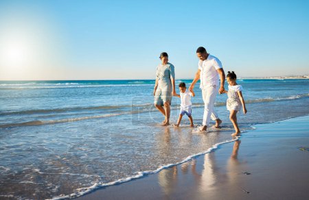 Photo for Family travel, beach walking and holding hands with mother, father and kids at ocean on holiday. Vacation and parent care with mockup in summer outdoor with mom, dad and children by sea having fun. - Royalty Free Image
