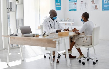 Foto de Covid, healthcare office and doctor with patient talking or healthcare communication for a medical note at her gp appointment or checkup. Black woman with health insurance visiting hospital or clinic. - Imagen libre de derechos