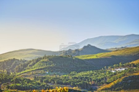 Photo for Mountains, environment and blue sky with nature, countryside and sunshine with landscape or weekend break. Empty, valley or grass with flowers or vacation with summer or travel with holiday or spring. - Royalty Free Image