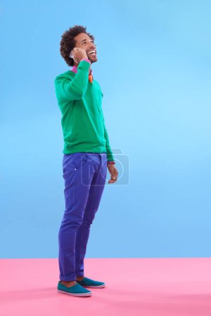 Photo for Fashion, black man and happy in studio with color block in clothes for trendy, style and outfit. Male person, stylist and fashionable for season trends with smile for funky, edgy and formal wear - Royalty Free Image