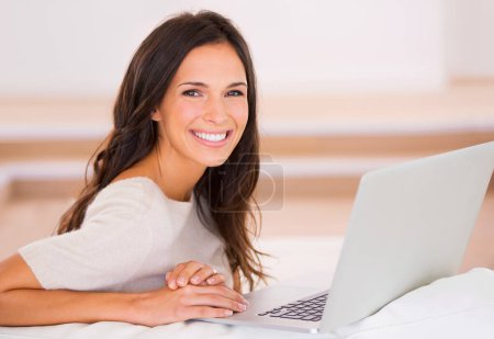 Photo for Woman, laptop and smile on sofa with remote work from home in portrait, living room and freelance editing. Person, writer and happy with pc on couch for typing, creativity and article in Barcelona. - Royalty Free Image