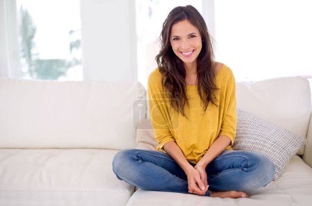 Photo for Woman, smile and sitting in portrait on sofa to relax in home with pride, holiday and confidence in living room. Person, happy and break on vacation in lounge with couch at apartment in Barcelona. - Royalty Free Image
