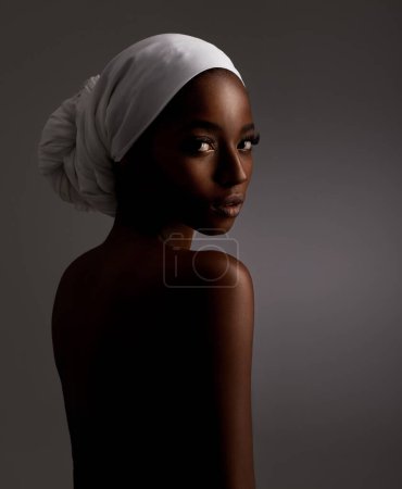 Photo for Portrait, beauty and culture with natural black woman in studio on gray background for wellness. Skincare, heritage and tradition with back of young person in headwear for cosmetics or dermatology. - Royalty Free Image