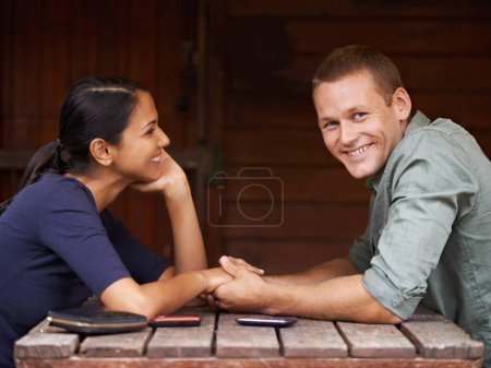 Photo for Love, holding hands and couple at a cafe with support, care and trust while bonding outdoor together. Marriage, romance or portrait of happy man at restaurant with wife for vacation, break or weekend. - Royalty Free Image