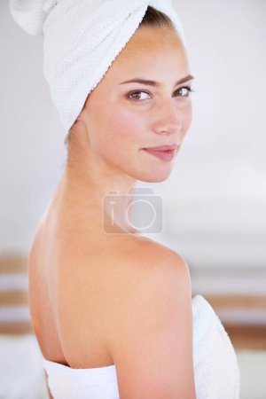 Photo for Portrait, beauty and skincare of woman in bathroom for wellness at home. Face, towel and natural cosmetics of young female person with spa facial treatment, dermatology or glow for healthy body care. - Royalty Free Image