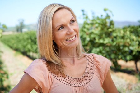 Photo for Mature, woman and vineyard with smile, thinking and nature for relaxation and sunshine. Person, summer and farm for rest, break and happiness with sustainable agriculture and holiday or vacation. - Royalty Free Image