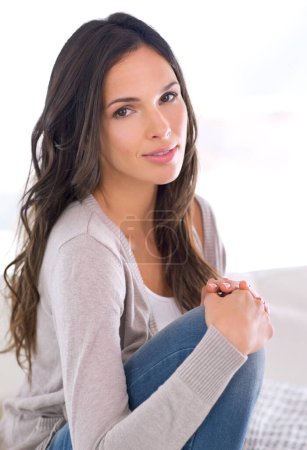 Photo for Woman, home and smile on couch to relax for break with me time to enjoy, day off and rest. House, living room and female person for leisure and cosy with peace, chill and wellness in England - Royalty Free Image