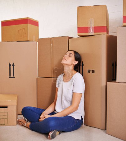 Photo for Woman, moving and boxes in living room for real estate, property investment and mortgage of new apartment. Homeowner, tired and female person with cardboard for home loan, relocation or renovation - Royalty Free Image