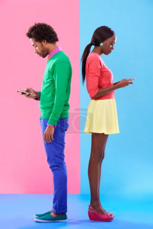 Photo for Couple, texting and phone in colorful clothes for fashion, dating or new love with crush. African people, young and serious for message on cell for flirting, conversation and chatting together. - Royalty Free Image